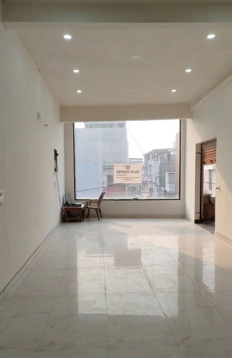Showroom interior with large glass window and marble flooring in Panipat
